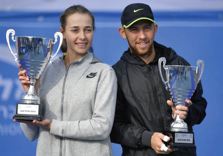 Dudi Sela (right) and Deniz Khazaniuk (left) hold their trophies after claiming their respective Israel national tennis championship titles.