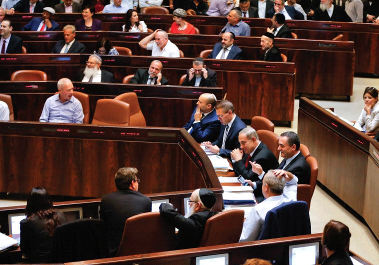 SHOW US the money. Lawmakers attend a preliminary vote on a bill at the Knesset