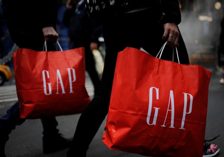 Shoppers carry bags from a Gap store [Illustrative]