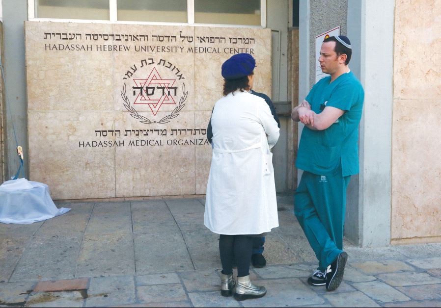 MEDICAL STAFFERS at Jerusalem’s Hadassah-University Hospital in Ein Kerem discuss yesterday’s call to strike.