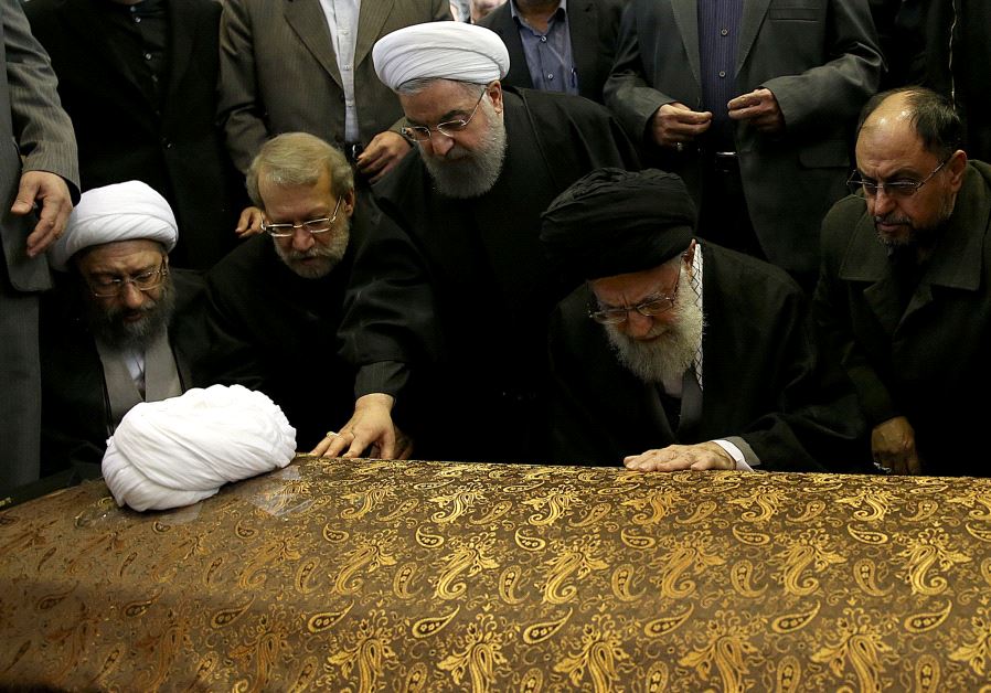 Iran's Supreme Leader Ayatollah Ali Khamenei and Iran's President Hassan Rouhani touch the coffin of former president Ali Akbar Hashemi Rafsanjani.