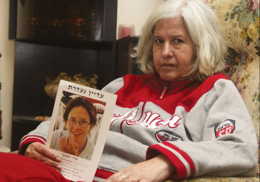 A notice showing Adi Yaakobi, who has been missing since 1996, held by her mother, Betty Yaakobi, who died of cancer in 2012