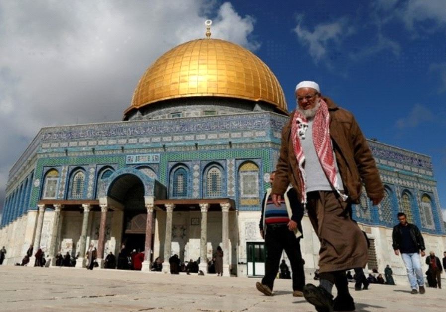 Palestinians walk past the Dome of Rock at the Al-Aqsa Mosque compound in Jerusalem's Old City, on January 13, 2017