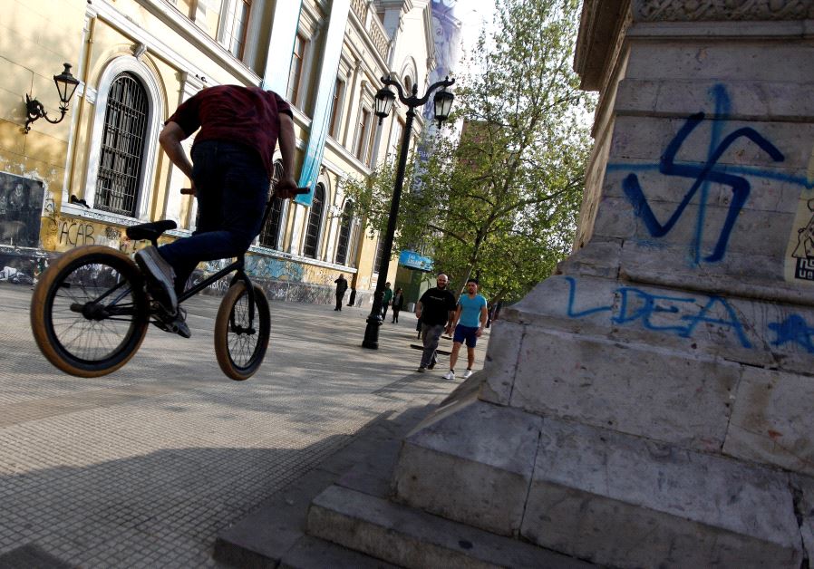 What appears to be a swastika spray-painted on a wall of the University of Chile in downtown Santiago [File]
