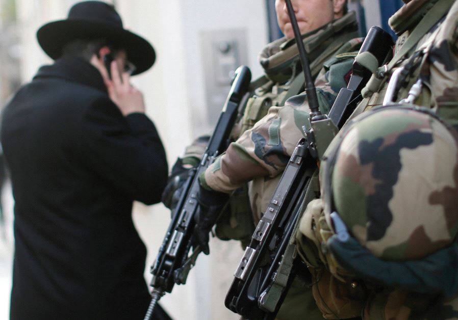 FRENCH SOLDIERS patrol the street in a Jewish neighborhood following a string of terrorist attacks in Paris in 2015.