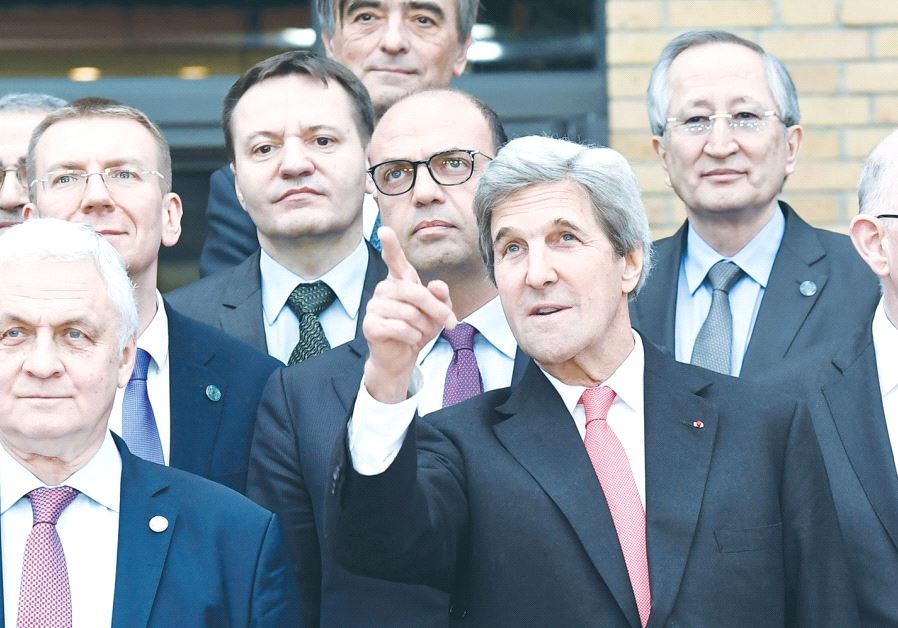 John Kerry standing among foreign ministers at Paris peace conference