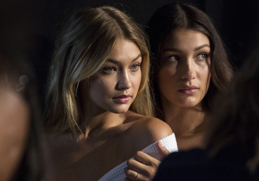 Models Gigi Hadid (L) and Bella Hadid pose for photos