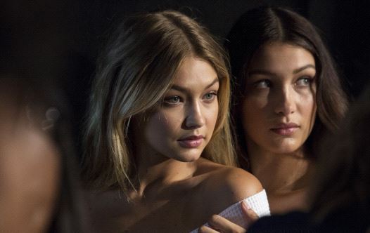 Models Gigi Hadid (L) and Bella Hadid pose for photos