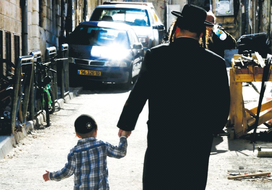 A Hassidic man with his child walking in Jerusalem
