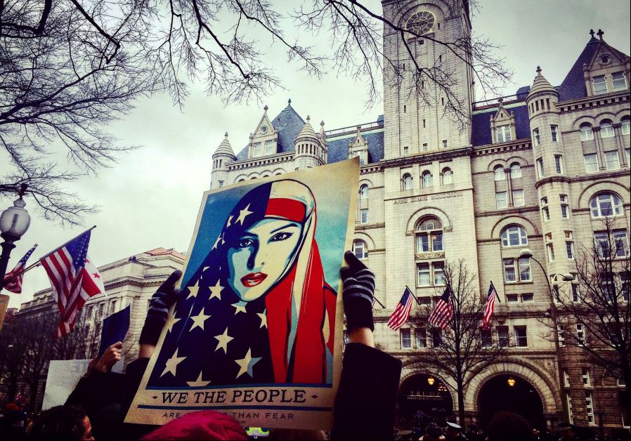 Protesters opposed to Donald Trump rally at Trump International Hotel on his inaugural parade route in Washington, DC.