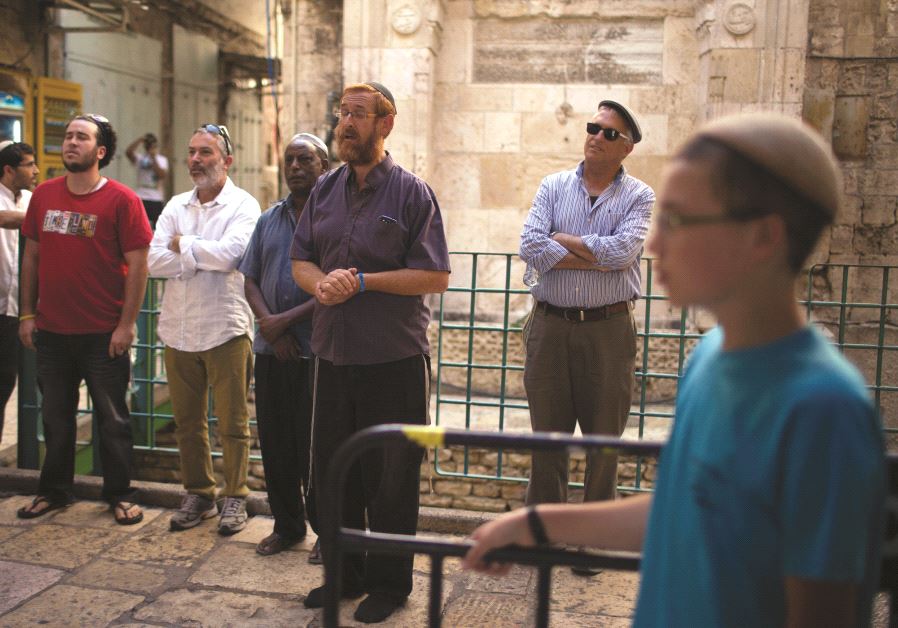 Yehouda Glick (au centre) priant à l’extérieur de l’enceinte du mont du Temple avec quelques fidèles