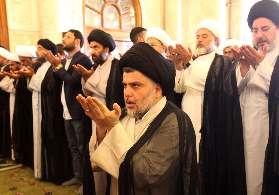 Iraqi Shi'ite radical leader Moqtada al-Sadr (C) takes part in Friday prayers at the Kufa mosque near Najaf, Iraq .