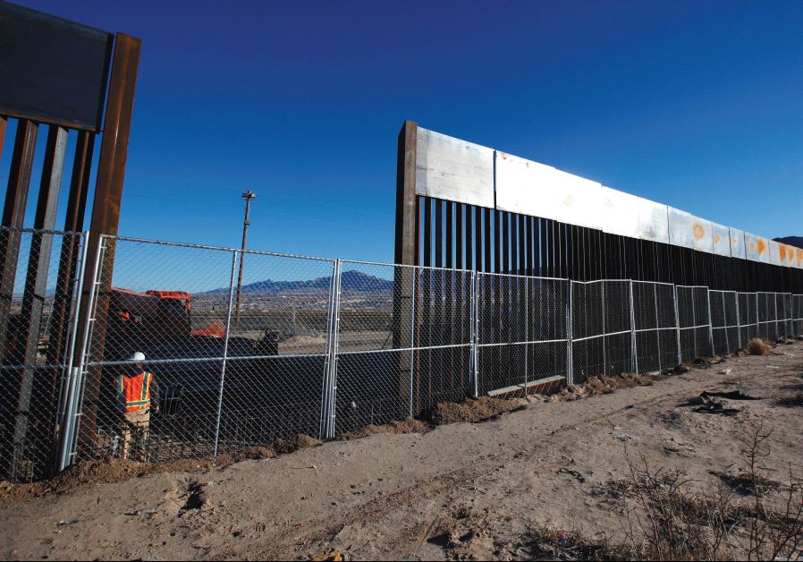 A WORKER STANDS next to a newly built section of the US border fence at Sunland Park, New Mexico, opposite the Mexican border city of Ciudad Juarez, on Wednesday. Picture taken from the Mexico side of the border.
