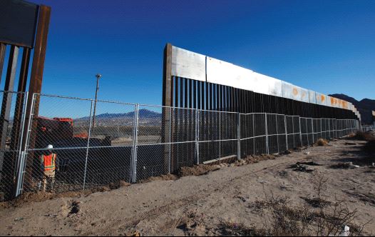 A WORKER STANDS next to a newly built section of the US border fence at Sunland Park, New Mexico, opposite the Mexican border city of Ciudad Juarez, on Wednesday. Picture taken from the Mexico side of the border.