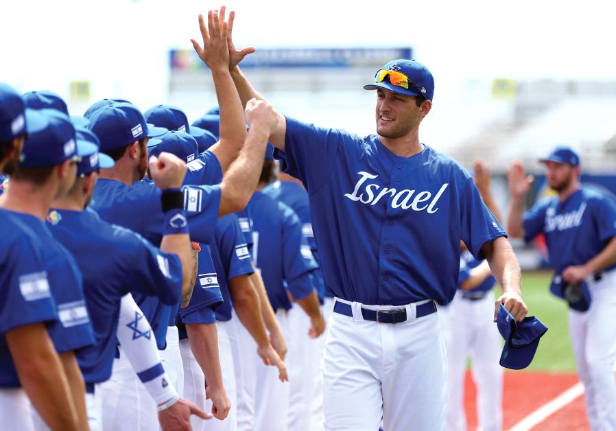 Nate Freiman high-fives his teammates during player introductions at a 2016 World Baseball Classic Qualifier at MCU Park in Brooklyn in September