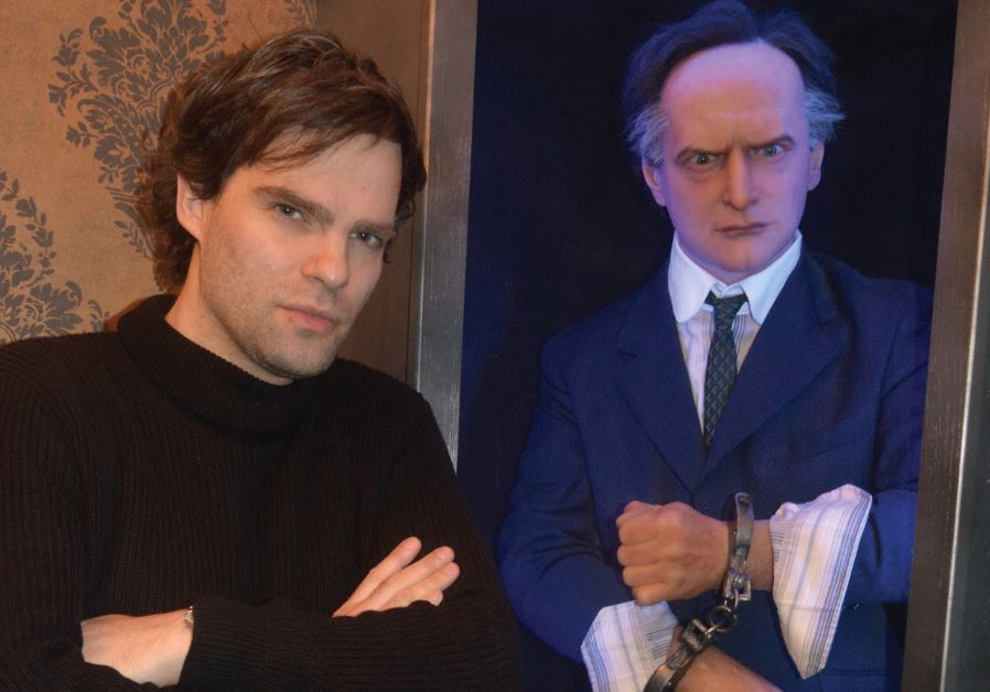 Hungarian-born escape artist David Merlini poses with a wax sculpture of Harry Houdini inside his House of Houdini museum in Budapest
