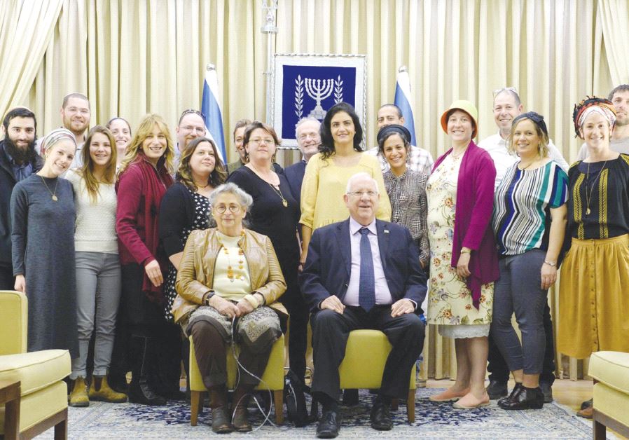 PRESIDENT REUVEN RIVLIN and his wife, Nechama, pose with members of the OneFamily community, whom they hosted at a Tu Bishvat Seder at his official residence in Jerusalem yesterday