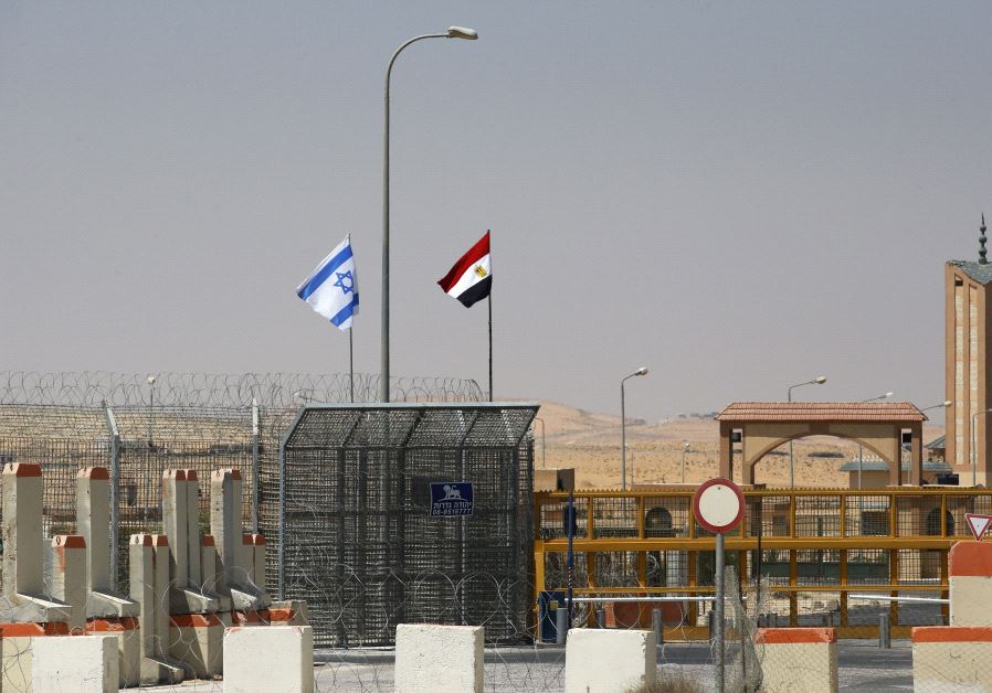 An Israeli flag (L) flutters next to an Egyptian one at the Nitzana crossing, along Israel's border with Egypt's Sinai desert