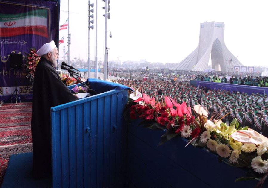 Iranian President Hassan Rouhani delivering a speech at Azadi Square in the capital of Iran ,  Tehran ,  during a ceremony to mark the 38th anniversary of the Islamic revolution.