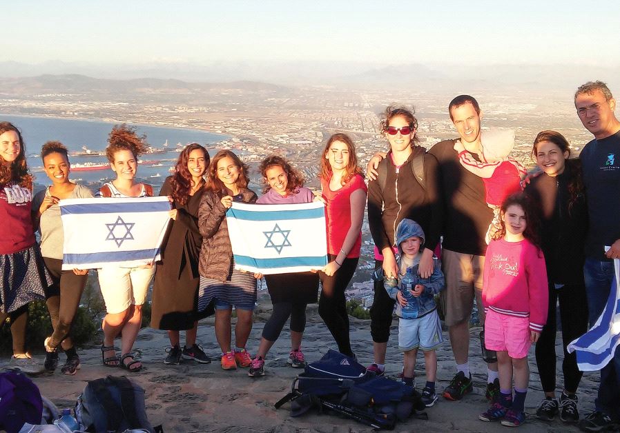 JEWISH AGENCY emissaries Aviad Sela (far right) and Hagai Dagan (holding the baby) pose for a photograph after a meeting of shlichim in Cape Town last year