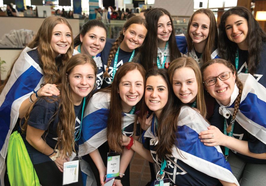 Teenage girls smile while attending the BBYO international convention in Dallas.