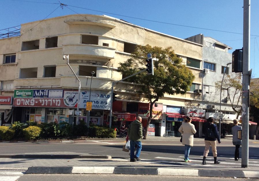 A once-elegant public building on the corner of Herzl and Bialik streets, in the heart of the Hadar