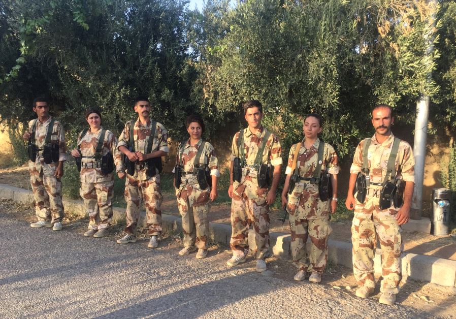 MEMBERS OF the Iranian-Kurdish Democratic Party of Iranian Kurdistan stand at attention at one of their bases
