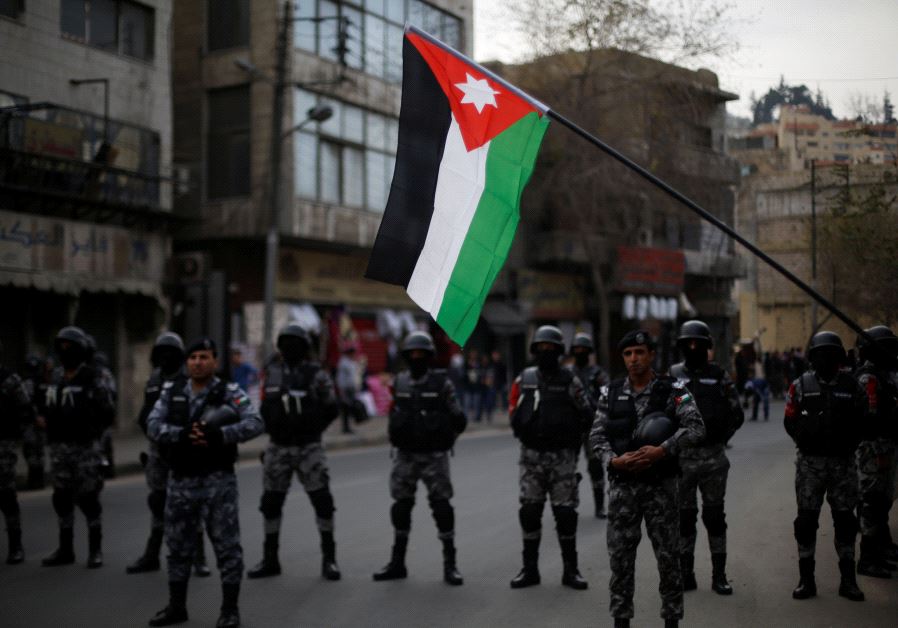 Jordanian policemen stand guard during a rally to support security services after shooting at Karak castle, in Amman, Jordan, December 23, 2016