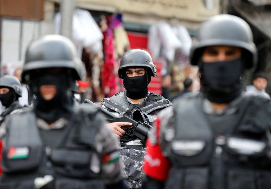 Jordanian policemen stand guard during a rally to support security services after shooting at Karak castle, in Amman, Jordan, December 23, 2016. 