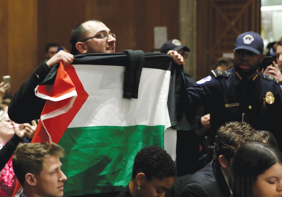 A MAN with a Palestinian flag shouts anti-Israel slogans in Washington.