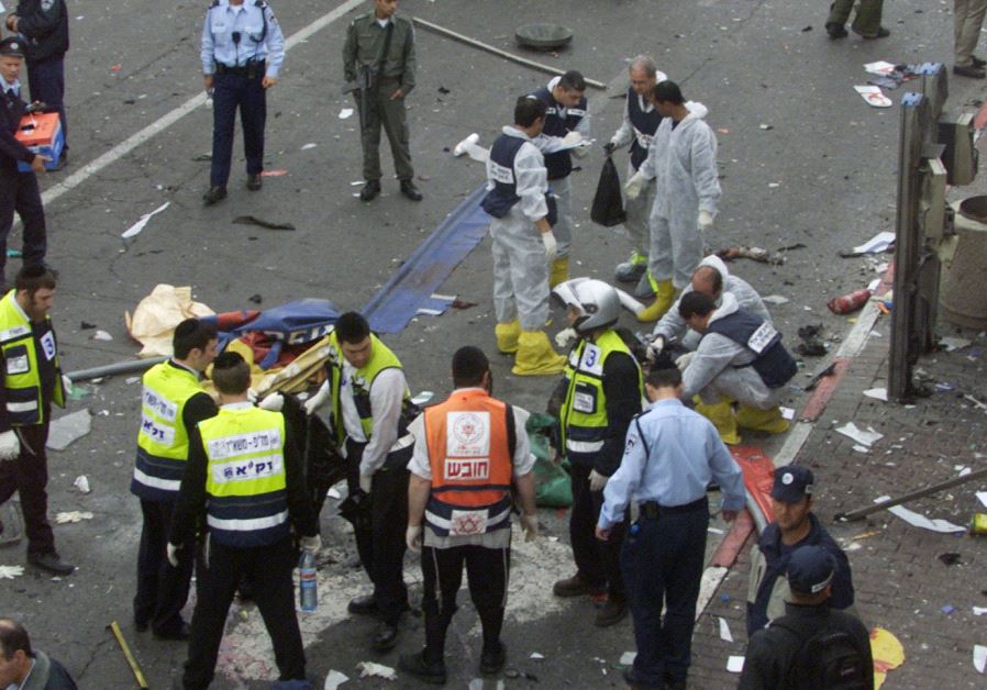 Investigators surround the body of a suicide bomber following an explosion near the Sbarro pizzeria on the junction of Jaffa Road and King George Street in Jerusalem