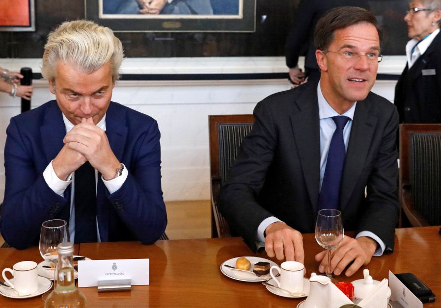 Dutch Prime Minister Mark Rutte (R) of the VVD Liberal party and Dutch far-right politician Geert Wilders of the PVV Party