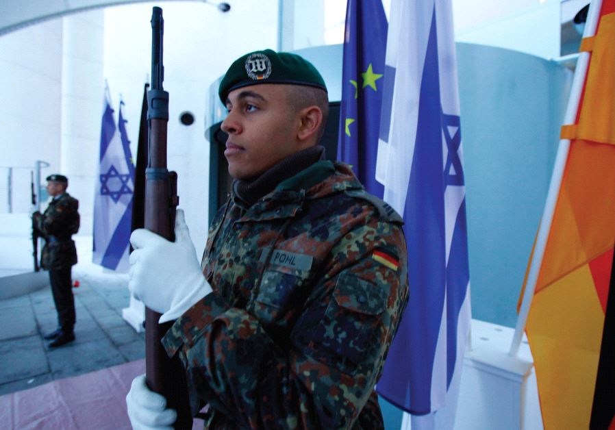 THE NEW normal. German soldiers stand guard next to Israeli, German and EU flags at the Chancellery in Berlin in 2012.