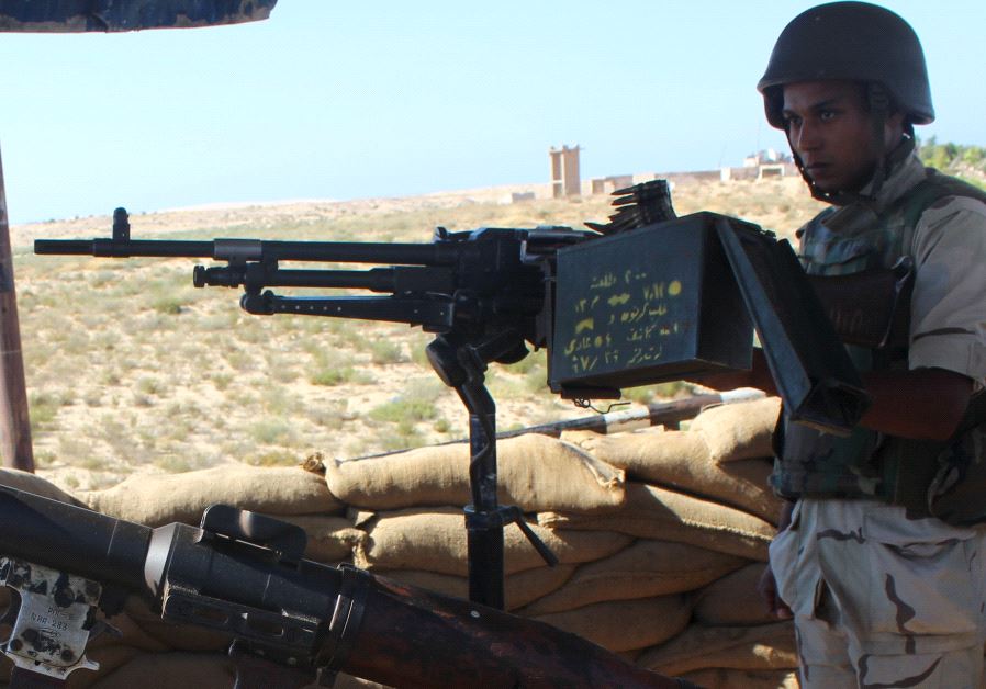 An Egyptian army soldier looks on from his postion at a checkpoint in Al Arish city, the troubled northern part of the Sinai peninsula