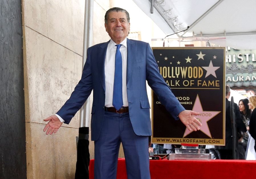 Israeli-American producer Haim Saban poses on his star after it was unveiled on the Hollywood Walk of Fame, March 22, 2017