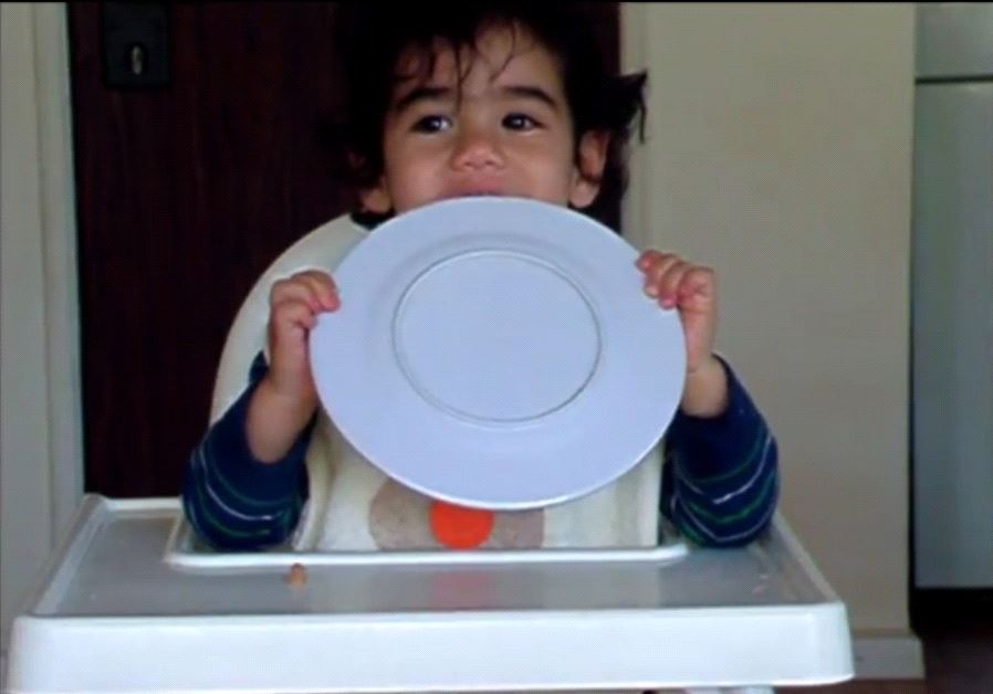A baby tries gefilte fish for the first time.