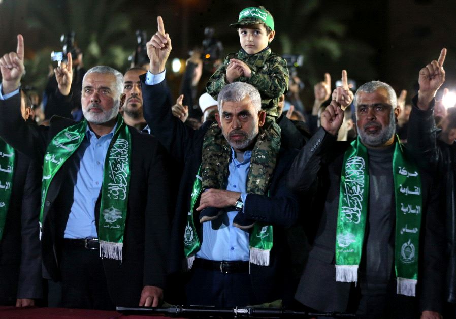 The son of senior Hamas militant Mazen Fuqaha sits on the shoulders of Hamas Gaza Chief Yehya Al-Sinwar during a memorial service for Fuqaha, in Gaza City March 27, 2017 