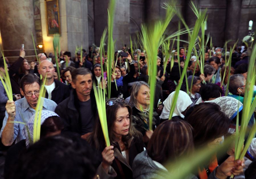 Christian worshippers take part in a Palm Sunday ceremony in the Church of the Holy Sepulchre in the Old City of Jerusalem