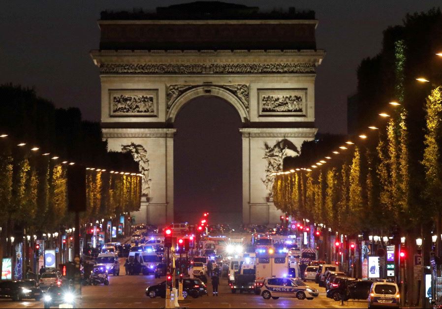 Police secure the Champs Elysees Avenue after a shooting incident in Paris, France