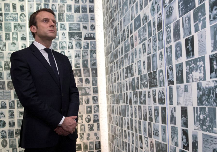 Emmanuel Macron, candidate for the 2017 presidential election, looks at some of the 2,500 photographs of young Jews deported from France during WWII, as he visits the Shoah Memorial in Paris, France, April 30, 2017