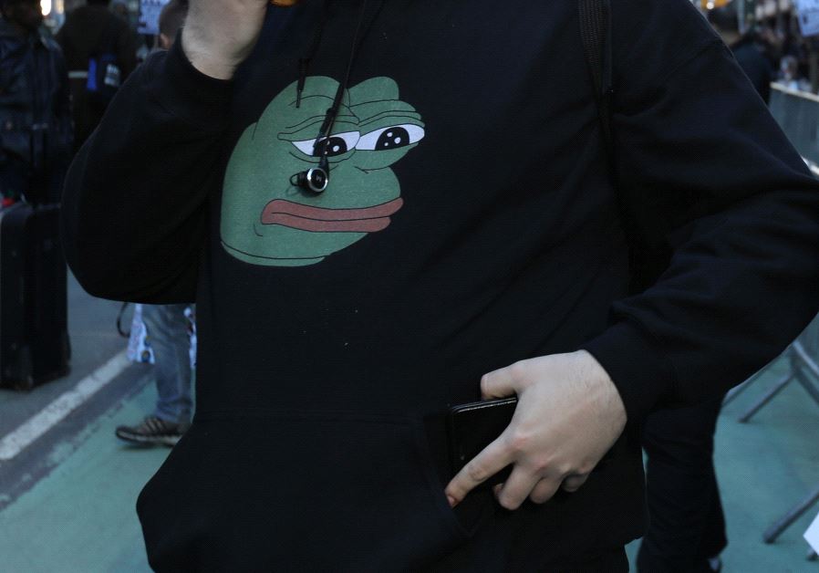 A man wears a Pepe the Frog sweatshirt 