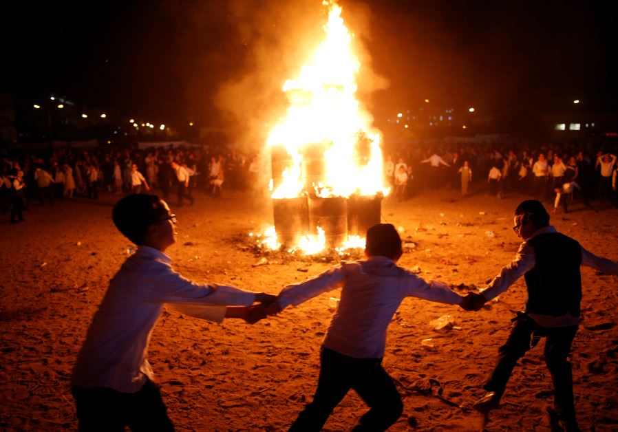 Ultra-Orthodox Jewish boys dance around a bonfire as they celebrate the Jewish holiday of Lag Ba'Omer in the city of Ashdod, Israel May 13, 2017