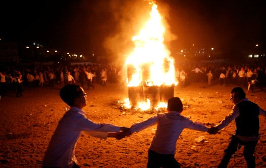 Ultra-Orthodox Jewish boys dance around a bonfire as they celebrate the Jewish holiday of Lag Ba'Omer in the city of Ashdod, Israel May 13, 2017