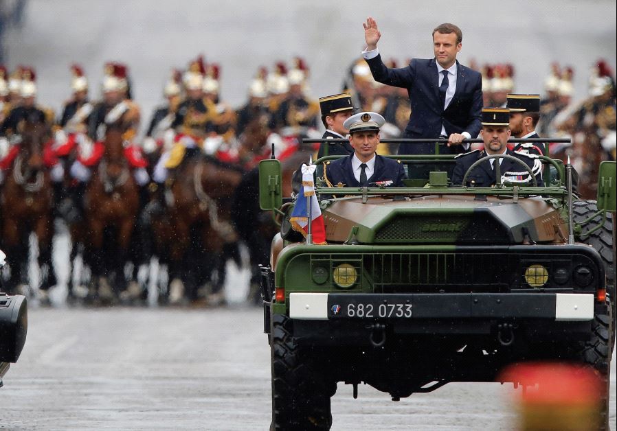 Newly elected French President Emmanuel Macron parades in a military vehicle in Paris after his inauguration, May 14