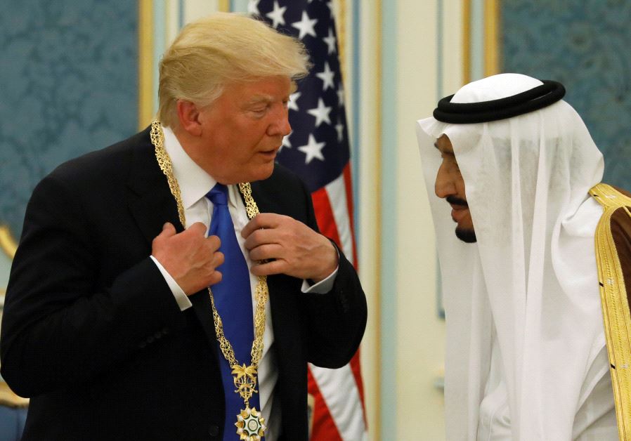 Saudi Arabia's King Salman bin Abdulaziz Al Saud (R) presents US President Donald Trump with the Collar of Abdulaziz Al Saud Medal at the Royal Court in Riyadh, Saudi Arabia