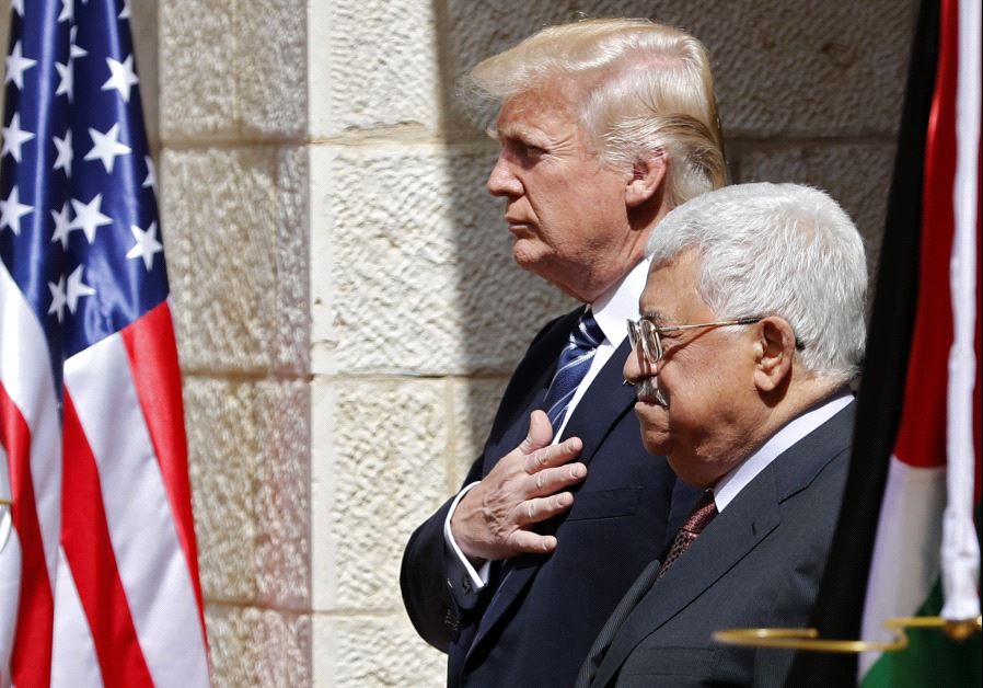 Palestinian Authority President Mahmoud Abbas (R) and US President Donald Trump listen to anthems during a welcome ceremony at the Presidential Palace in Bethlehem on May 23, 2017