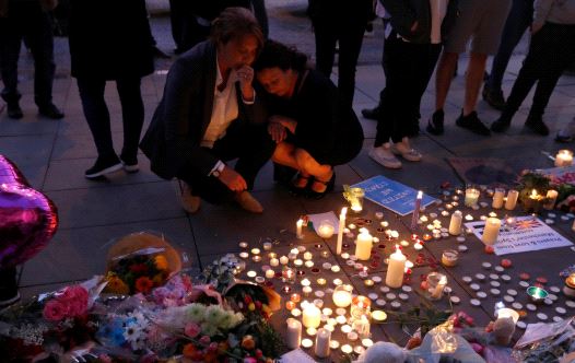 People pay their respects to the victims of the deadly suicide bombing in Manchester that took place during an Ariana Grande concert. 