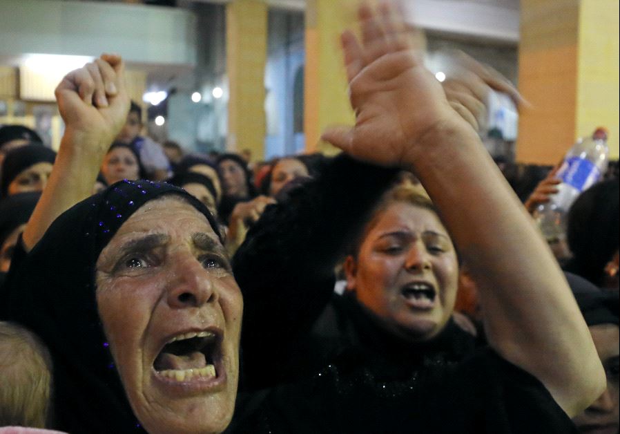Relatives of victims of an attack that killed at least 28 Coptic Christians on Friday react at the funeral in Minya, Egypt May 26, 2017.