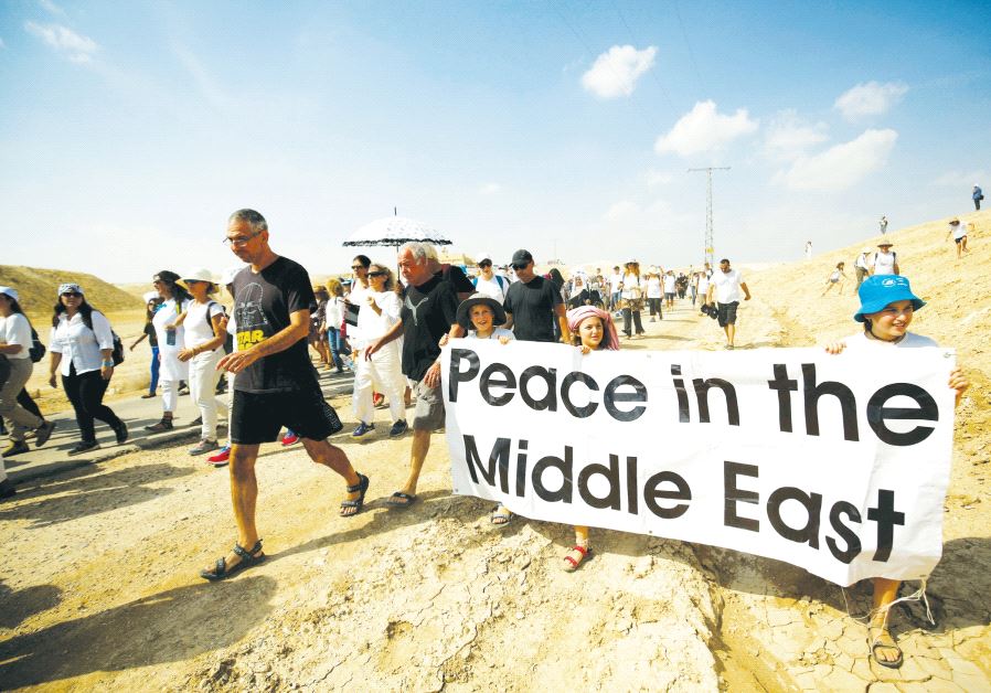 Demonstrators including Israeli and Palestinian activists take part in a demonstration in support of peace near Jericho last year