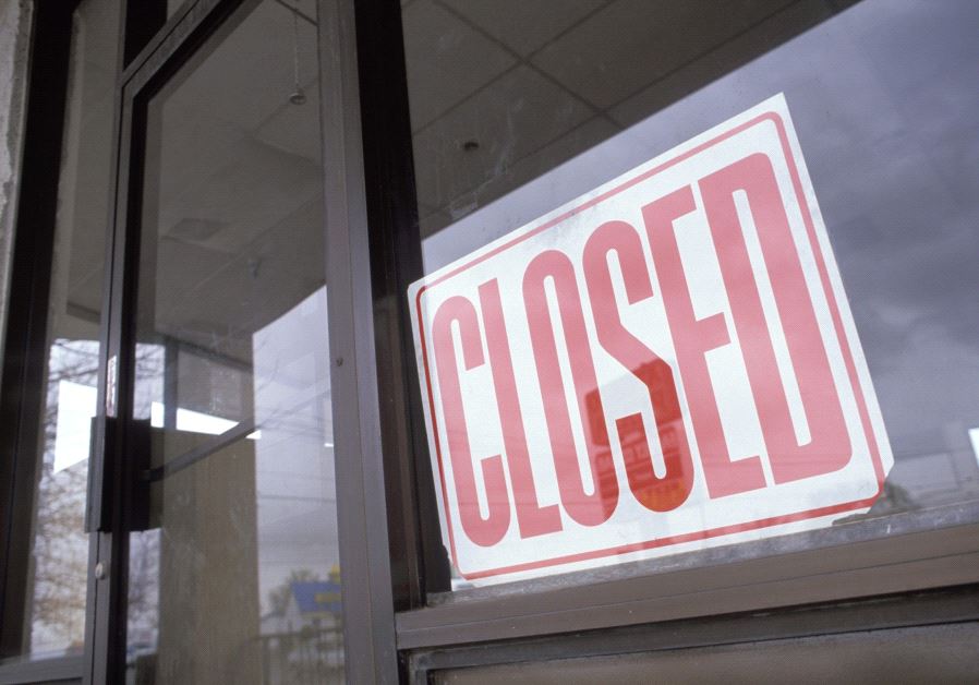 Vacant department store with closed sign in window